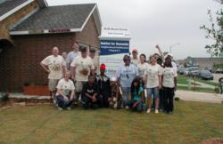 MJB Employees around Habitat for Humanity Signage